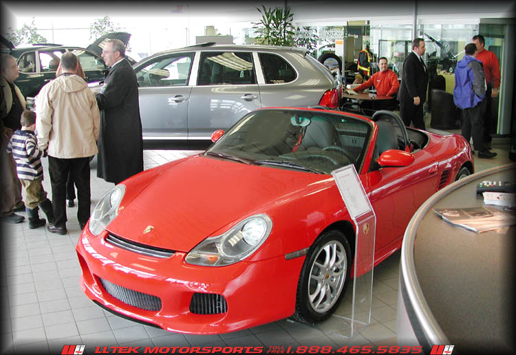 Guards Red Boxster on showroom floor sporting all new Aero- Styling