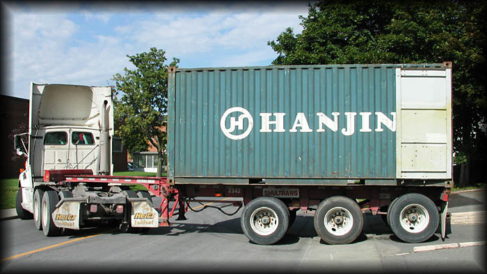 The latest LLTek container shipment pulls into the shipping dock.